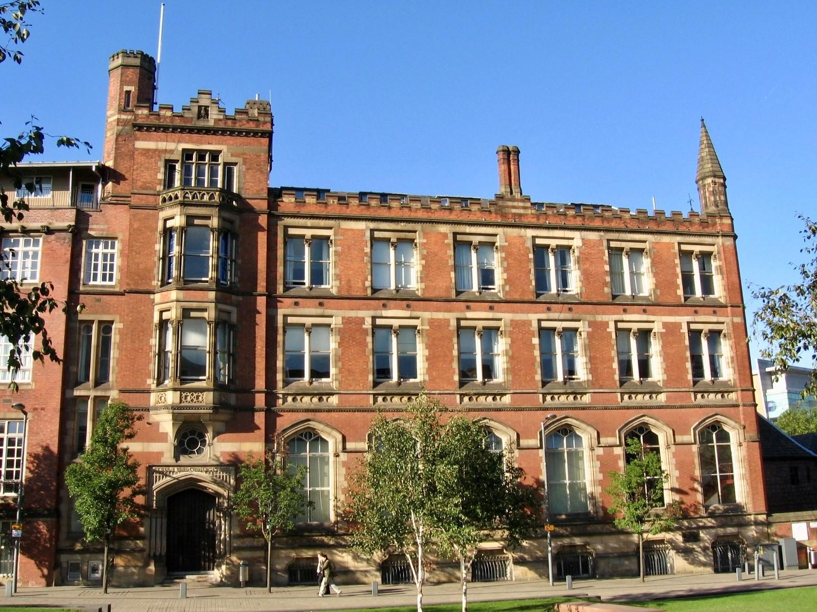 External image of a very large and proud Victorian building. It is three storeys with feature arch windows at the ground floor. 