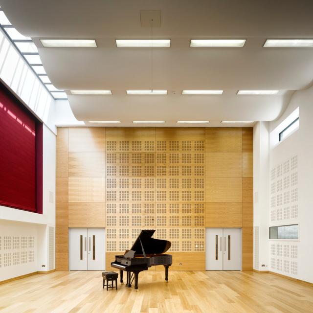 a rehearsal room at rncm with grand piano against a timber paneled wall