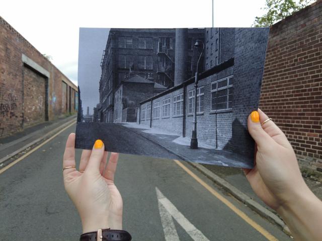 holding up a black and white photo in front of its current context
