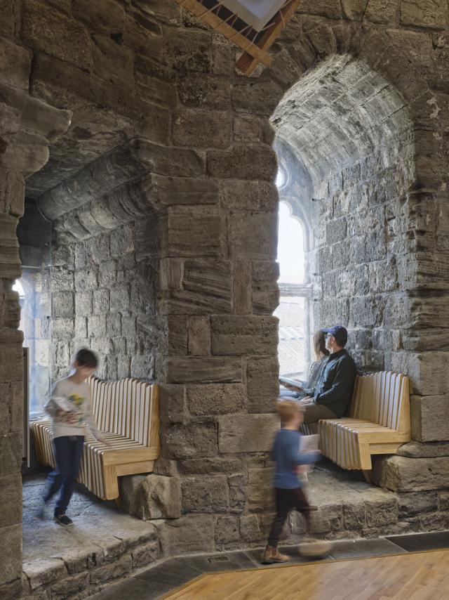 a family sits in the window seats at caernarfon castle